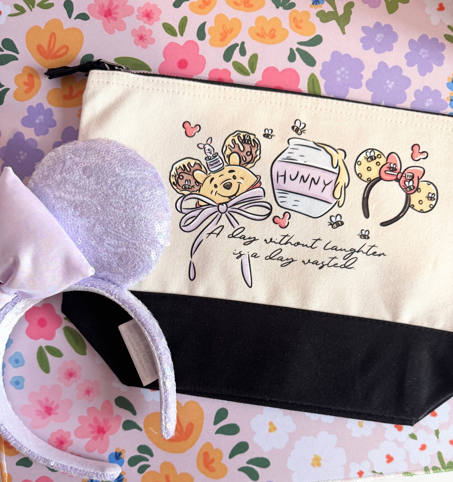 Pouch with cartoon design and text on a floral background